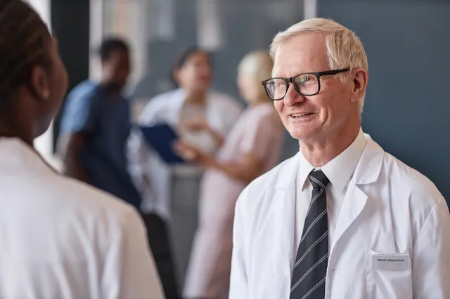 Senior physicians in discussion after a medical seminar